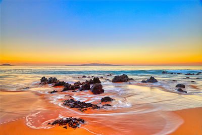 Colorful Keawakapu Beach, Maui, Hawaii shoreline with lava rocks at sunrise