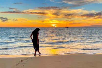 Silhouette of woman at Maui beach sunset