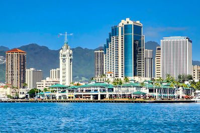 Honolulu skyline seen from the water with iconic Aloha Tower on left